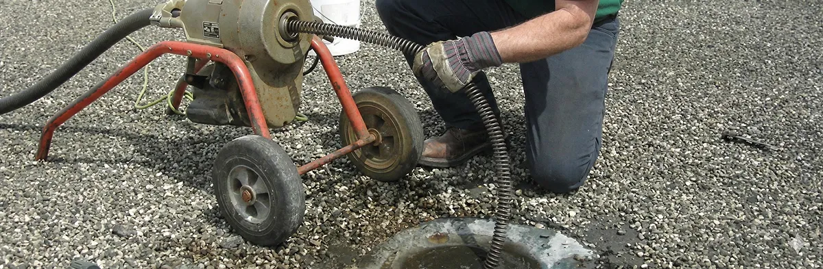 sewer rodding technician actively removing blockages from a sewer line in Naperville, IL